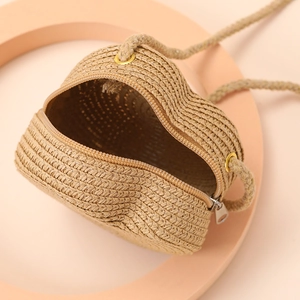 Top view of heart straw bag interior showing woven texture and metal zipper