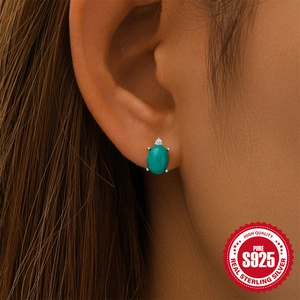 S925 Sterling silver turquoise flower moon stud earring shown on model earlobe