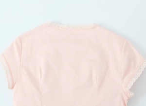 Detail view of pink round neck blouse with lace trim and flutter sleeves stitching