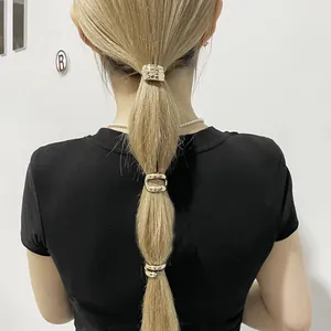 Detailed view of three minimalist gold alloy ponytail hair cuffs styled on a model ponytail