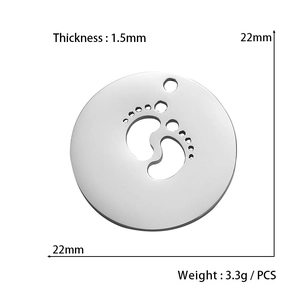 Macro detail of a 22mm silver pendant with baby footprint cutout and polished finish