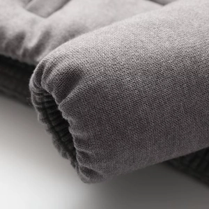 Close-up of gray knitted ribbed cuffs on a winter cotton jacket showing fabric texture