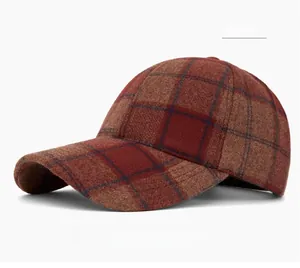Detail of vintage plaid baseball cap in dark red showing thick textured winter fabric