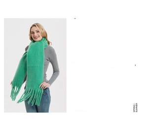 Detail view of vibrant green thick mohair scarf with fringe trim worn with grey top