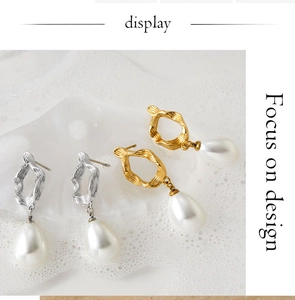 Detailed view of gold and silver irregular metal hoop earrings with elegant pearl pendants