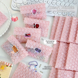 Detail shot of pink heart-shaped bubble wrap mailer for secure gift packaging