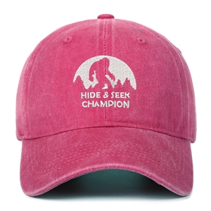 Detailed embroidery of Bigfoot Hide and Seek Champion on washed pink cotton baseball cap