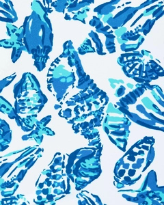 Detailed pattern of starfish and sea shells on blue and white long sleeve surf suit fabric