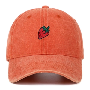 Close-up of strawberry embroidery on vintage orange washed cotton baseball cap