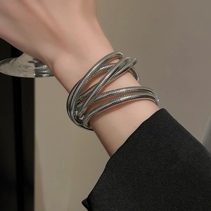 Macro shot of silver multi-layered elastic cuff bracelet with industrial ribbed texture