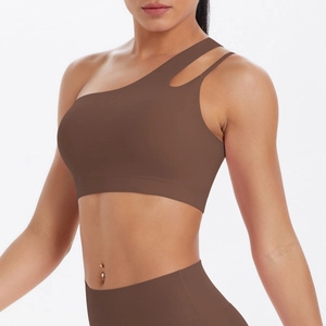 Close-up of asymmetric single shoulder strap with parallel hollow details on sports bra