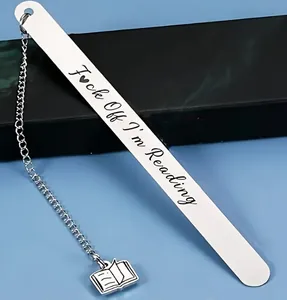 Detailed view of stainless steel bookmark with engraved text and open book charm