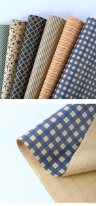 Detail of blue grid kraft paper rolls with self-adhesive backing and cutting grid lines