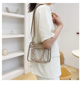 Detail of transparent PVC crossbody bag with rhinestone trim and dual straps