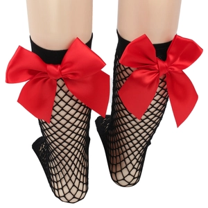 Detail of girls' black fishnet mesh socks featuring a large red satin bow on the back
