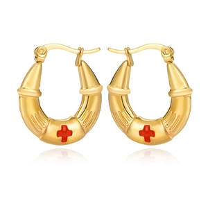 Polished gold horn earrings with red cross accent in a minimalist streamline design
