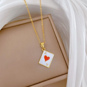 Detail of gold titanium steel necklace with ace of hearts pendant on a velvet box