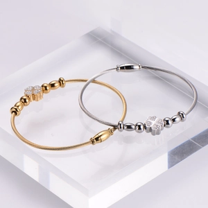 Two-piece stainless steel wire bangles set with diamond clover charm in gold and silver