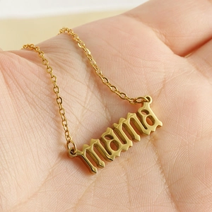 Gold stainless steel necklace featuring a mama letter pendant held in a person's palm