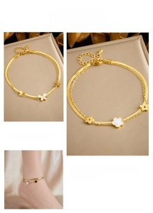 Close-up of double-layer gold anklet with white shell butterfly and floral charms