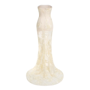 Detailed view of champagne lace embroidery on the mermaid back of the strapless dress