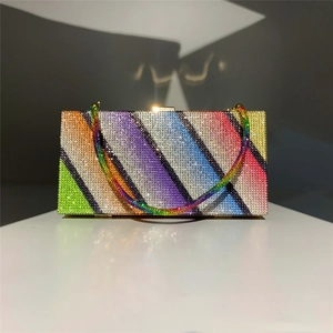 Close-up of rainbow rhinestone clutch bag featuring sparkling colorful crystal stripes