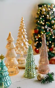 Macro shot of glass Christmas trees with ribbed textures and glowing LED lights inside