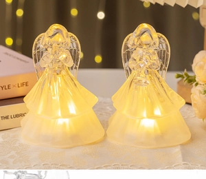 Detail of crystal-like praying angel LED night lights with warm yellow glowing effect