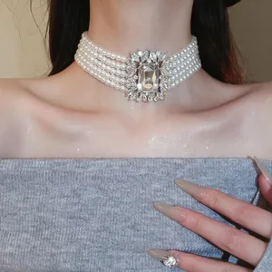 Luxurious five-layer pearl choker with a sparkling rectangular crystal centerpiece