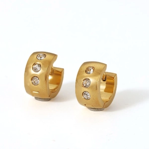 Close-up of 18K gold plated hoop earrings featuring three sparkling zircon stones