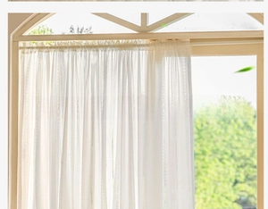 Detail of white lace sheer curtain with vertical stripes and rod pocket design