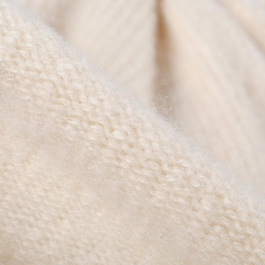 Close-up of beige knitted beanie for women featuring premium thermal wool texture