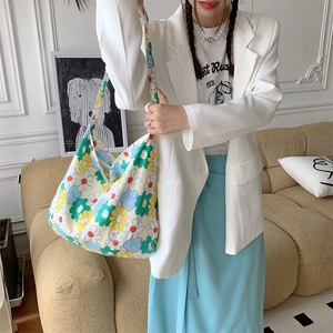Floral canvas tote bag with daisy prints shown in a minimalist home lifestyle setting