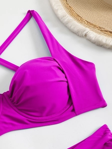 Detail of fuchsia bikini top featuring underwire support and elegant pleated fabric texture
