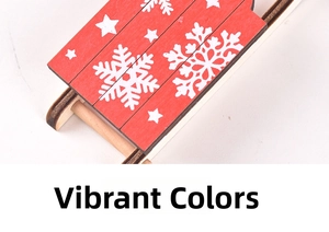 Detail of red wooden Christmas sled ornament with white snowflake and star patterns