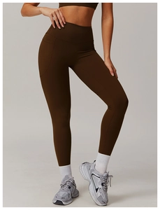 Close-up of high-waisted yoga pants with side pockets in breathable dark brown fabric