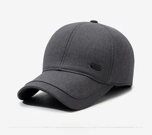 Detail view of charcoal gray twill baseball cap with side brand tag and curved brim