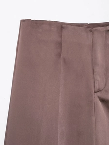Close-up of Mocha brown satin trousers showing waist tailoring and silky fabric texture