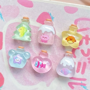 Detail shot of miniature resin wishing bottles with cork stoppers in diverse cute shapes