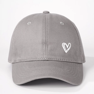 Close-up of heart embroidery on dark grey cotton baseball cap with twill texture