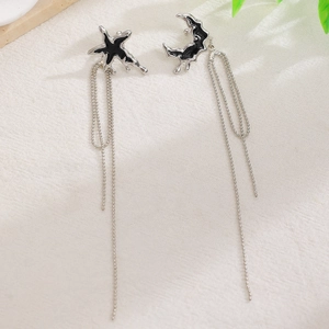 Asymmetric long chain earrings with black enamel star and moon liquid lava charms