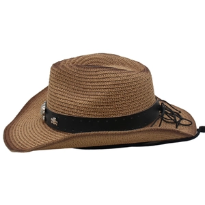 Detail of straw cowboy hat featuring a gradient finish and silver skull ornament