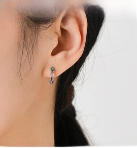 Close-up of S925 silver hoop earrings with mint green, pink, and navy enamel chain links