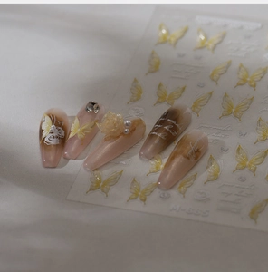 Macro detail of M-885 butterfly nail stickers with 3D pearls and resin floral charms