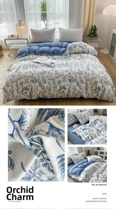 Detail of floral printed duvet cover with blue orchid patterns and contrast backing