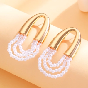 Detail of French vintage layered pearl tassel earrings with U-shaped gold metal frame