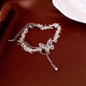 Detail of crystal butterfly bracelet with adjustable alloy chain on brown silk