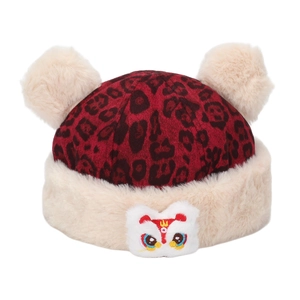 Detail of winter kid hat featuring red leopard print and plush lion dance embroidery