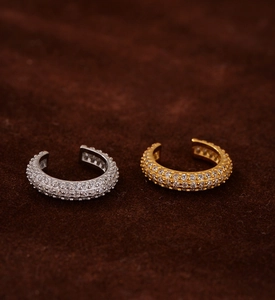 Macro detail of gold and silver S925 sterling silver ear cuffs with pavé cubic zirconia