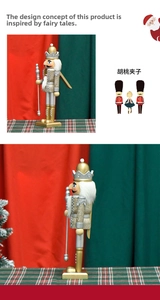 Detailed view of a 30cm gold and silver wooden nutcracker king with glitter and crown